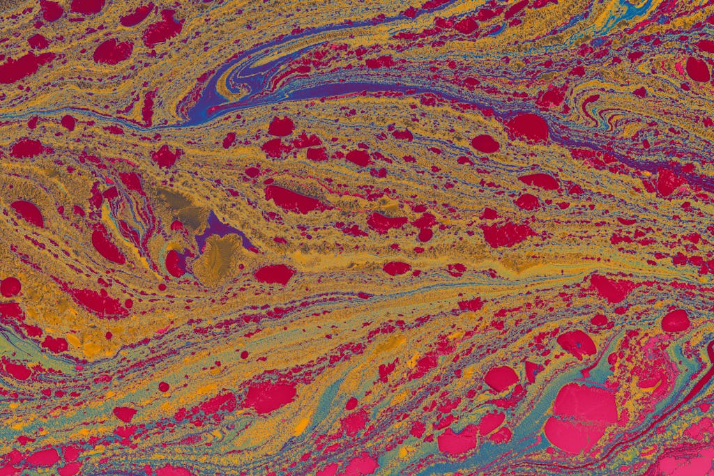 Colorful abstract fluid art with earth tones and vibrant patterns.